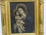 painting of a woman holding a child in a gold frame