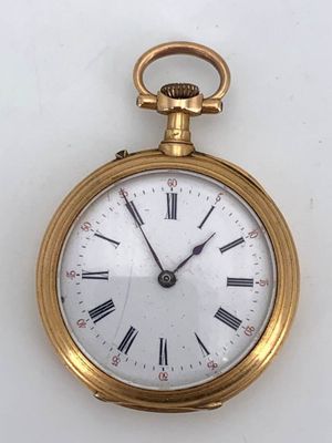 a gold pocket watch with roman numerals on the face