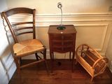 two chairs and a table with a lamp on top of it
