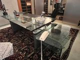 a glass table with a phone on it in the middle of a room