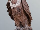 a statue of a bird on a rock on a table