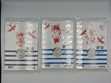 three silver coins are in a plastic bag on a white surface