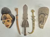 several different types of african masks are displayed on a white surface