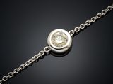 un bracelet en diamants suspendu à une chaîne sur fond noir