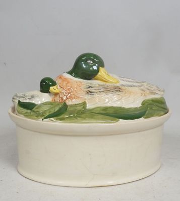 a white bowl with a duck on top of it