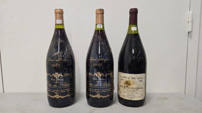 three bottles of wine are lined up on a counter
