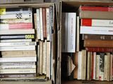 two boxes full of books sitting on the floor