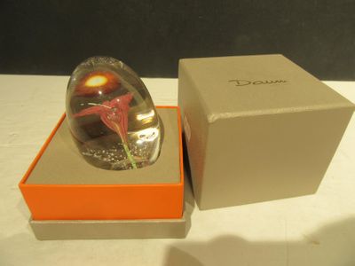 a glass ball with a flower inside of it in a box