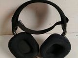 a pair of black headphones sitting on a white surface