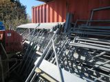a pile of metal chairs sitting on the side of a building