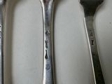 three spoons and a fork sitting on a table