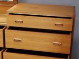 a wooden dresser with a mirror on top of it