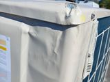 a white refrigerator sitting outside of a building with a blue sky in the background