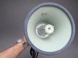 a man holding a large white and blue megaphone