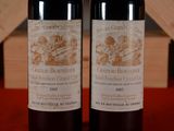 two bottles of wine sitting next to each other on a table