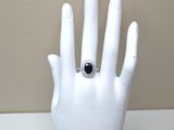 a white hand with a black and white ring on it