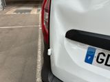 a white car parked in a parking lot next to a parking meter