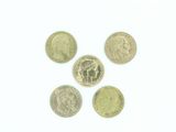 Quatre pièces de monnaie britanniques sont disposées en cercle sur une surface blanche.
