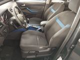 the interior of a car with a blue stripe on the front seat