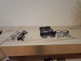 several pairs of glasses and a pair of shoes are sitting on a table