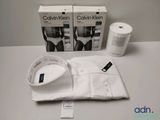 two boxes of calvin klein underwear and a cup of coffee