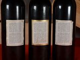 three bottles of wine that are sitting on a table
