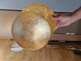 a person that is holding a gold ball in their hand