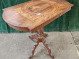 an old wooden table with a wooden top on a stand