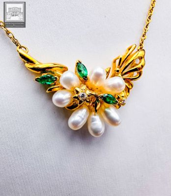 gold plated necklace with white pearls and green leaves