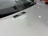 a sticker on the hood of a car that has a sticker on it
