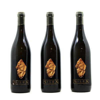 three bottles of wine with a gold leaf on the label