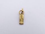 a close up of a gold plated pendant on a white surface