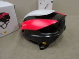 a helmet that is sitting on the floor next to a box