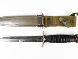 two knives that are laying side by side on a white surface
