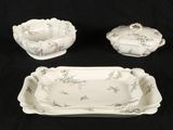 three pieces of porcelain dishes and a bowl on a black background