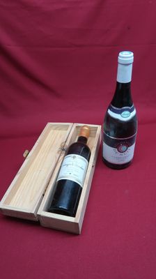 a bottle of wine in a wooden box next to a bottle of wine