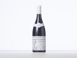 a bottle of red wine sitting on a table