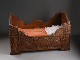 carvings on the bed frame are carved to look like elephants