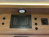 a control panel on the side of a wooden table