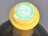 a bottle with a yellow cap on it sitting on a table