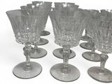 several empty wine glasses sitting on top of each other on a white surface