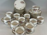 a lot of cups and saucers sitting on a table