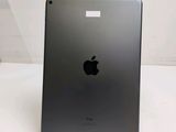 an apple ipad is sitting on a stand on a white surface