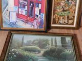 three framed pictures on the floor next to a window