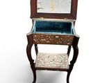 a small wooden table with a mirror on top of it