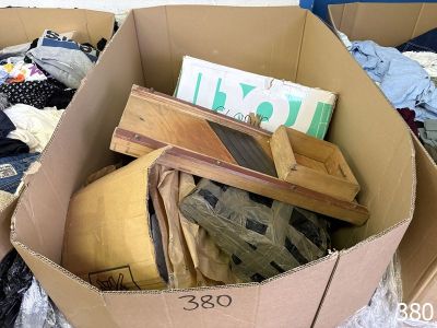 a cardboard box filled with clothes and other items