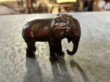 statue of an elephant standing on a table in a room
