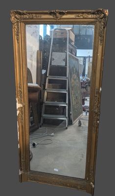 a mirror that is sitting on the floor in a room