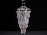 a glass cup with a lid sitting on a table