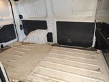 a white van with the door open and the floor missing